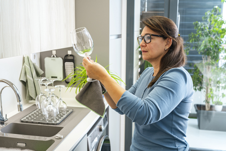 woman checking a newly washed wine glass